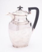A George V silver hot water jug by Atkin Brothers, Sheffield 1923, of oval tapering form,