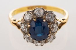 An 18ct gold sapphire and diamond cluster ring,