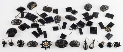 A collection of antique jet, to include carved jet brooches, odd earrings,