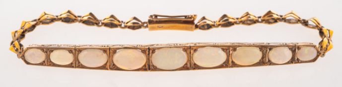 An Art Deco opal bracelet, nine graduated opal cabochons set in an articulated engraved setting,