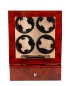 A wooden wristwatch display cabinet with automatic wind for four watches.