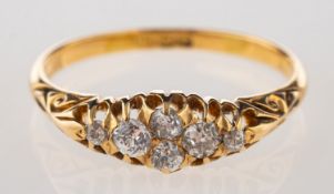 An antique diamond ring, of gypsy style with carved scroll shoulders set with six old-cut diamonds,