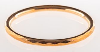 A 9ct gold 1920's slave bangle, of diamond pattern, UK hallmark, inside diameter approx. 7.2cm, 12.