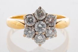 An 18ct gold diamond daisy ring, set with seven brilliant-cut diamonds, diamonds approx. 1.
