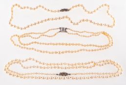 A group of three pearl necklaces, including a long strand of graduated cultured pearls approx.