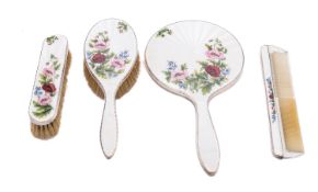 An Elizabeth II silver and enamel cased five piece dressing table set by Asprey & Co.