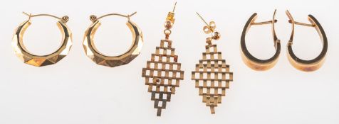 A group of three pairs of earrings, including a pair of 9ct gold 'huggie' style hoop earrings,