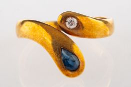 A sapphire and diamond snake ring, set with a brilliant-cut diamond and a pear-shaped blue sapphire,