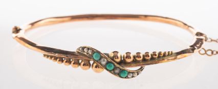 An antique turquoise and seed pearl bangle, hinged with push-in clasp and safety chain,