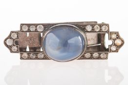 An Art Deco clip, set centrally with a moonstone cabochon,