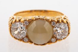 An impressive cat's eye chrysoberyl and diamond ring, purchased from Garrard & Co, Regent Street,