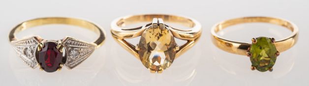 A group of three gem-set rings, including a 9ct gold ring set with an oval-cut citrine,