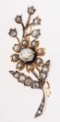 A Victorian diamond and pearl floral spray brooch, the flowerhead set with an old oval-cut diamond,