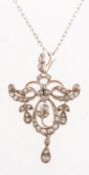 An Edwardian diamond pendant and chain, an ornate pendant of openwork scroll and foliate design,
