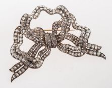 A Victorian diamond bow brooch, set with old-cut and cushion-cut diamonds in the form of a bow,