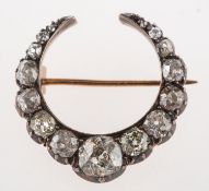 A Victorian diamond crescent brooch, set with old cushion-cut and rose-cut diamonds,