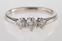 A platinum three stone ring, claw set with three brilliant-cut diamonds, diamonds approx. 0.