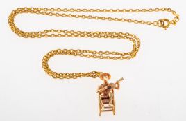 A chain with a pendant of a seated gentleman, a flat edged belcher link chain, unmarked,