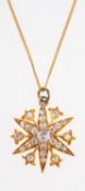 An Edwardian star pendant with chain,
