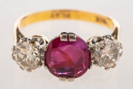 A ruby and diamond three stone ring, set centrally with a circular-cut ruby, approx. 1.
