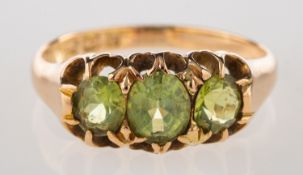 A Victorian 15ct gold peridot ring, set with three oval-cut peridot, UK hallmark, size K1/2 to L, 2.