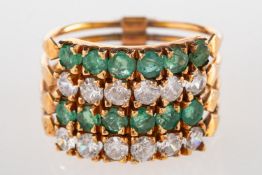 An emerald and paste stone stacking ring, made up of four bands,