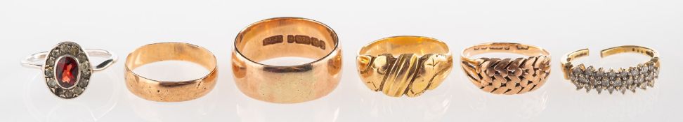 A group of six rings, including a 9ct gold wide wedding band, UK hallmark, size T, 8.