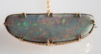 An opal brooch, set with an elongated white oval opal cabochon in a claw & basket setting, pin,