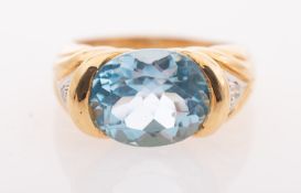 A vintage blue topaz and diamond ring, a cocktail ring set with an oval mixed-cut blue topaz,