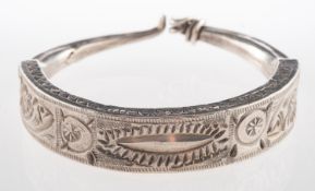 An ornately carved bangle, possibly a Berber bangle, with hook clasp, indistinct Foreign marks,