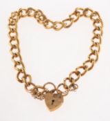 A 9ct gold curb link bracelet, with heart padlock and safety chain, indistinct UK hallmark,