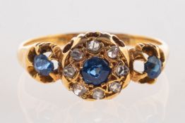 An 18ct Victorian sapphire and diamond ring, set with three circular-cut sapphires,