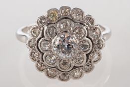 A diamond daisy halo ring, set with old-cut diamonds in the form of a flowerhead, diamonds approx.