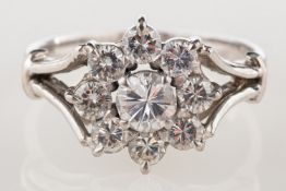 A vintage diamond daisy ring, of flowerhead form and claw set with brilliant-cut diamonds,