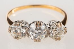 A fine antique three stone diamond ring, double claw set with three old European cut diamonds,