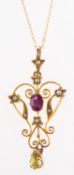 An Edwardian pendant with chain, the pendant of openwork design and set with an oval-cut garnet,