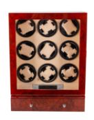 A wooden wristwatch display cabinet with automatic wind for nine watches.