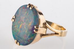 An opal doublet ring, double claw-set with an oval opal doublet, measuring approx.