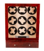 A wooden wristwatch display cabinet with automatic wind for nine watches.
