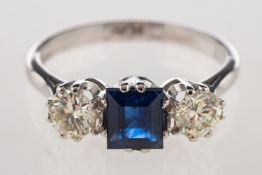 A sapphire and diamond three stone ring, set to the centre with a rectangular-cut sapphire,
