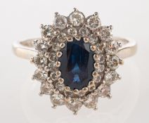 An 18ct white gold sapphire and diamond cluster ring,