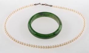 A jade bangle and a pearl necklace, a small jade bangle, inner diameter approx. 5.5cm, 34.