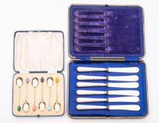 A set of six George V silver and enamel multi coloured coffee bean spoons by Fergenbaum & Son,
