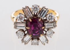 An 18ct gold ruby and diamond cluster ring, set centrally with an oval-cut ruby, ruby approx. 0.