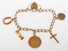 A 9ct gold charm bracelet with charms, with heart padlock and safety chain, UK hallmark,