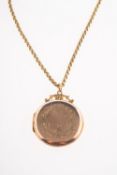 An antique locket and chain, a circular locket with floral and foliate engraving,