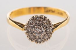 A diamond cluster ring, with a central brilliant-cut diamond and a surround of single-cut diamonds,