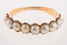 A Victorian half hoop ring, set with nine split pearls, unmarked & untested, size O, 1.7grams.