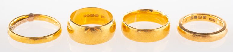 A group of four 22ct gold wedding bands, UK hallmarks, sizes vary from I1/2 to O,