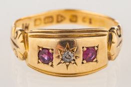 An 18ct gold Edwardian ring, star set with an old-cut diamond and two circular-cut red stones,